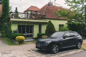 a black car parked in front of a house at Dům cestovatele in Uherský Brod