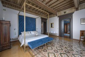 a bedroom with a large bed with a blue canopy at Tenuta Il Poggio - Luxury B&B in Felegara +57 photos
