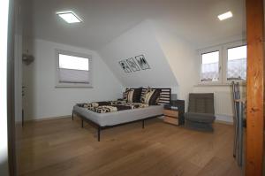 a living room with a couch and a chair at Haus Schambachtal in Treuchtlingen