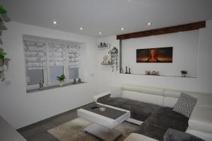 a living room with a couch and a table at Haus Schambachtal in Treuchtlingen
