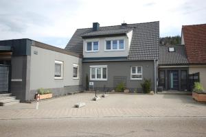 a house with a parking lot in front of it at Haus Schambachtal in Treuchtlingen