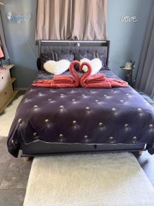 a bed with two towels on top of it at Maison cocooning , avec double jacuzzi et piscine in La Machine +46 photos