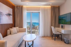 a living room with a couch and a table at Hotel Teuta in Sarandë
