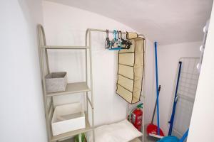 a bathroom with shelves and hangers in a room at Cuencaloft El 3 in Cuenca +8 photos