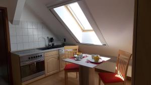 a kitchen with a table and a skylight at Ferienwohnung Mohnblume in Gerswalde