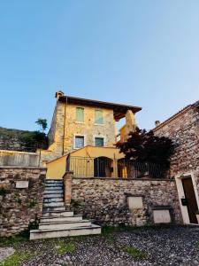 an old stone building with stairs in front of it at Casa Dolca Casa La Torre in Pozzolengo