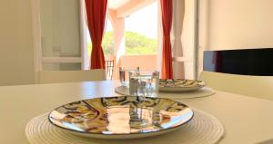 a table with two plates of food on top of it at Dimora Mary - Vicino al mare in La Maddalena +15 photos