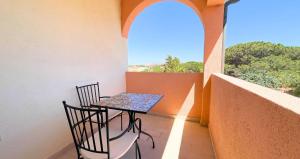a table and chairs on a balcony with a window at Dimora Mary - Vicino al mare in La Maddalena