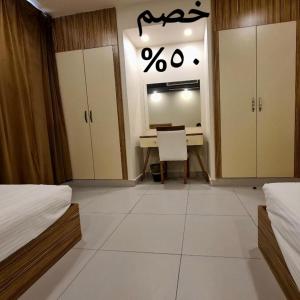 a bedroom with a desk and a desk at SPAR Serviced Apartments- سيبار للشقق المخدومة in Al Hofuf