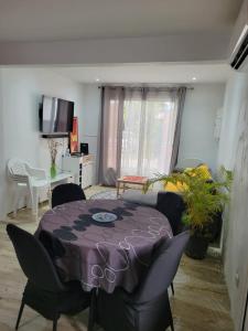 a living room with a purple table and chairs at Hibiscus holiday in Capesterre-Belle-Eau