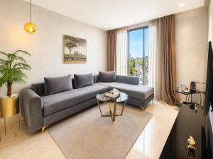 a living room with a couch and a table at ZEN Suites Hotel Massira in Casablanca