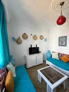 a living room with a couch and a tv at Duplex Marina Monastir in Monastir +9 photos