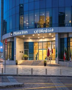 a building with a sign that reads plaza inn at Plazza In Hotel in Doha
