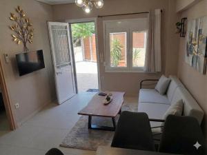 a living room with a couch and a table at Joannas Luxury Apartment in Corfu