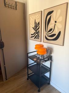a shelf in a room with two pictures on the wall at Agde centre historique avec vue in Agde +6 photos