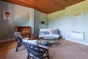 a living room with a couch and a table at Maison T2 - Le Boichot in Dole +1 photo