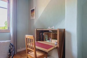 a desk with a chair next to a wall at Maison T2 - Le Boichot in Dole