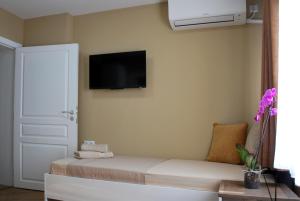 a living room with a couch and a tv on the wall at BS Brother in Ruse