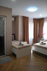 a bedroom with two beds and a window at BS Brother in Ruse