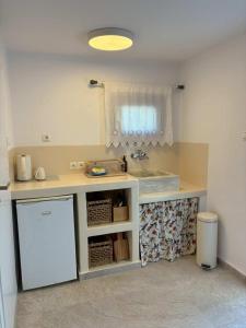 a kitchen with a counter with a sink and a dishwasher at Anamnisi Studio in Adamantas +51 photos