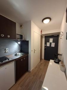 a kitchen with a sink and a counter top at Le 540 - Annecy - Parking in Annecy