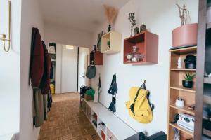a hallway with shelves and a yellow bag on the wall at Bel appartement balcon - 2 personnes in Malakoff
