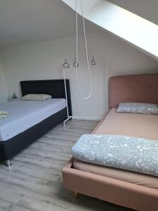 two beds in a room with two bedsskirts at Pension Rückert in Kassel
