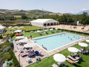 an overhead view of a swimming pool with umbrellas at ll Crinale Village in Colli del Tronto