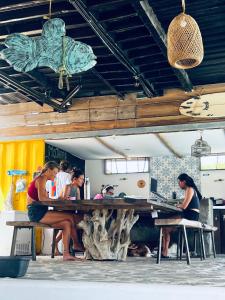 a group of women sitting at a table in a restaurant at Mojarra Beach-Wind Room- Santa Veronica in Salina de Rey