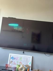 a flat screen tv hanging on a wall at Villa 24 maj cole vlore in Vlorë