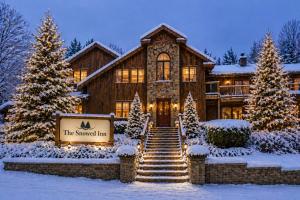 a house with a christmas tree in front of it at The Snowed Inn in Killington
