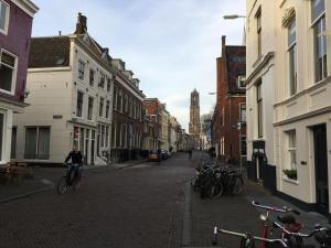 a man is riding a bike down a street at De Verrassing in Utrecht