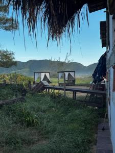 a view of a field with mountains in the background at Casa Praia - Recanto Tucuns Beira-Mar in Búzios