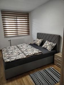 a bedroom with a bed and a window at Allegra lux in Sombor