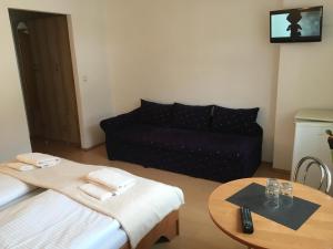 a living room with a couch and a table at Penzión Kýčera in Oščadnica