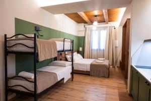 a room with three bunk beds and a window at ll Crinale Village in Colli del Tronto