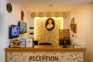 a reception desk in a room with a mirror at White Country Villages Hotel in Antalya