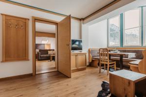 a living room with a door leading to a dining room at Landhaus Rohrmoser in Werfenweng