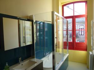 baño con lavabo, ducha y ventana en Canvas Atelier Hostel, en Oporto