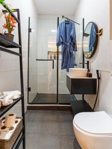 a bathroom with a shower and a toilet and a sink at M&N Apartment in Ikate +16 photos