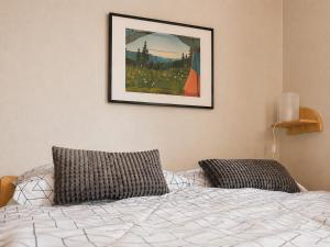 a bedroom with a bed and a picture on the wall at Penzión Liezky in Mýto pod Ďumbierom