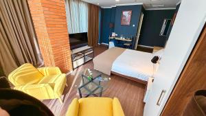 a hotel room with a bed and a table and chairs at Bricks Hotel in Tbilisi City