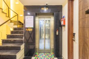 an elevator in a building with a colorful floor in front at Treebo Premium Paarth Grand with Pure Veg Restaurant in Haridwār