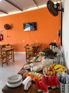 a table with a bunch of fruit on it at POUSADA ORTEGA in Bodoquena