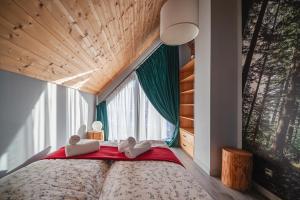 a bedroom with a large bed with a large window at Góralski Dom - Osada Gawlaki in Zakopane