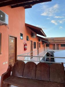 a bench sitting on a balcony of a building at POUSADA ORTEGA in Bodoquena
