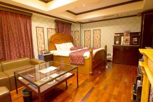a hotel room with a bed and a couch at Canon Himeji Higashi (Adult Only) in Himeji