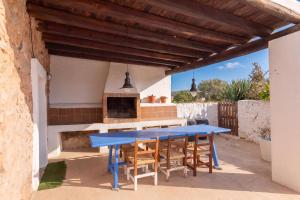 a blue table and chairs on a patio at New! Villa Can Marsoch in Santa Eularia des Riu