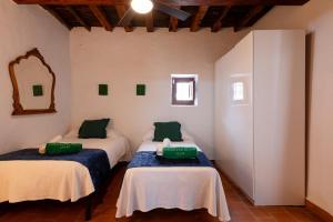 a room with three beds in a room at New! Villa Can Marsoch in Santa Eularia des Riu