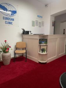 an office with a reception counter and a chair at Hotel Eurosan in Slănic-Moldova